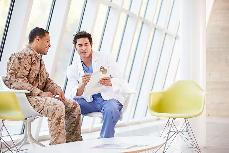 doctor explaining paper to soldier