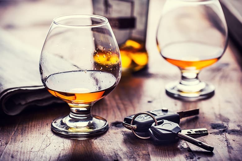 alcohol and car keys on table