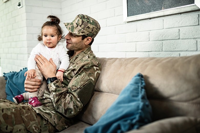 soldier holding baby girl