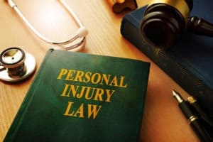 personal injury law book with gavel and stethoscope on table