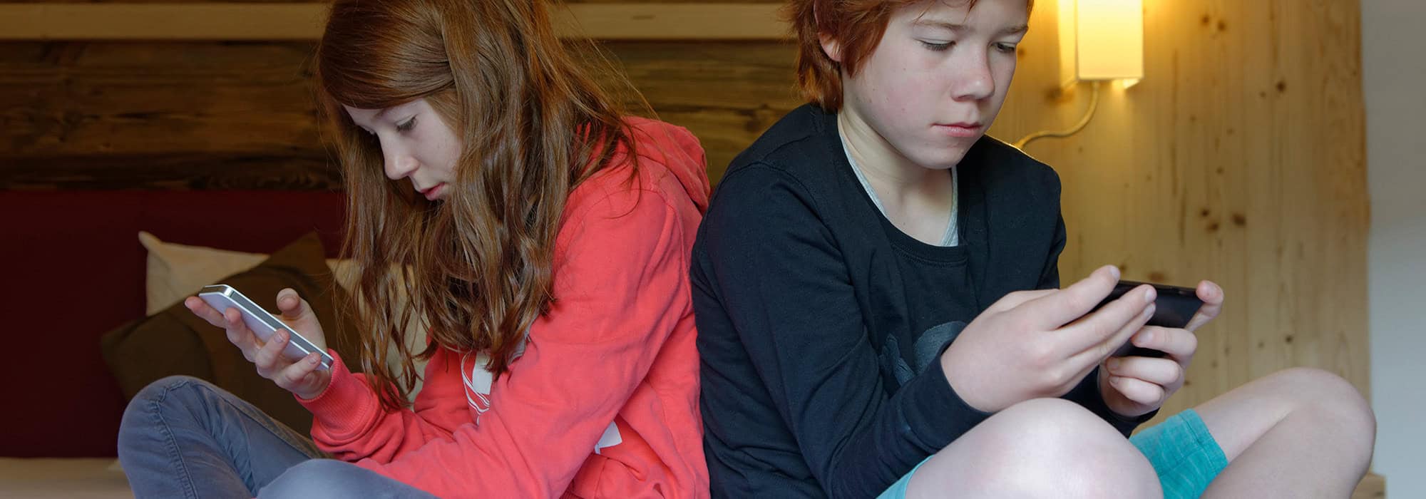 Siblings on their phones using social media